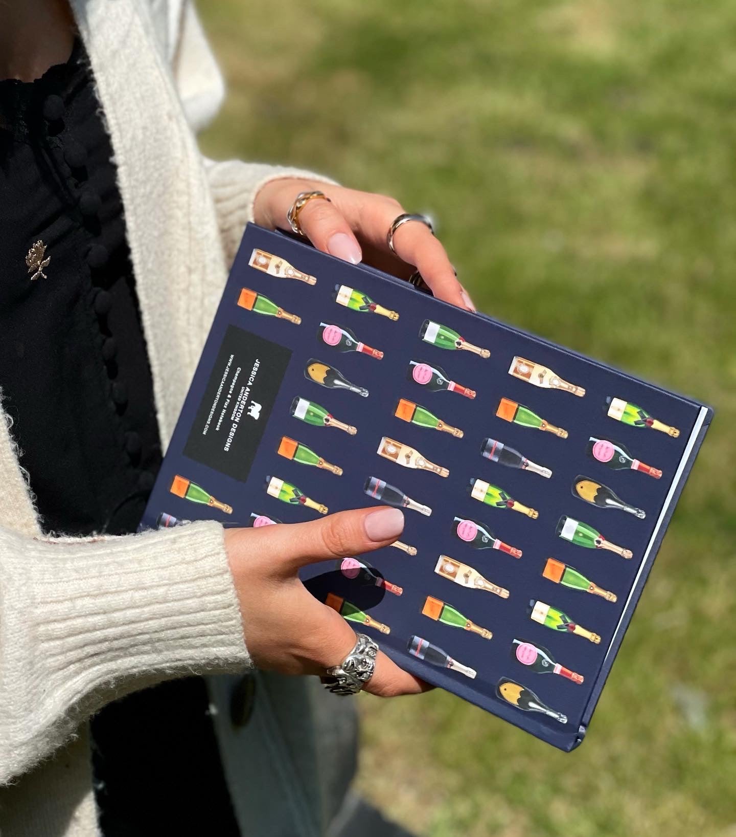 girl holding notebook champagne bottles