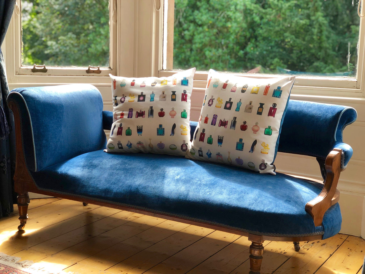 two cushions on chair perfume bottles