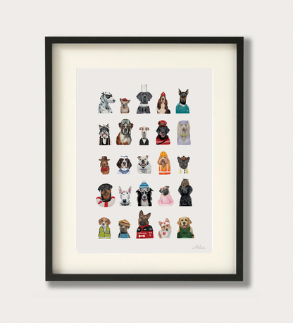 Framed wall art featuring a grid of small illustrated dog portraits in various outfits, shown in a black frame with a white mat against a light neutral background.